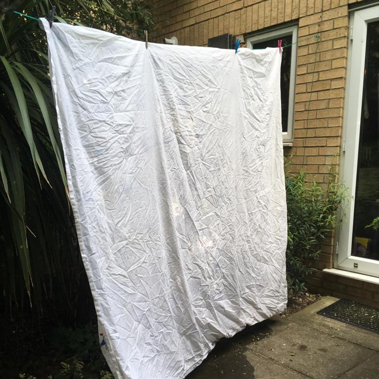 White sheet hanging on washing line